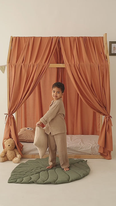Cozy toddler bed with khaki linen drape curtains
