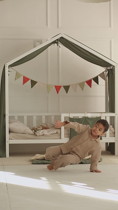 Khaki bed canopy with ties secured on both sides