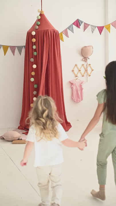 Boho nursery with warm cotton canopy