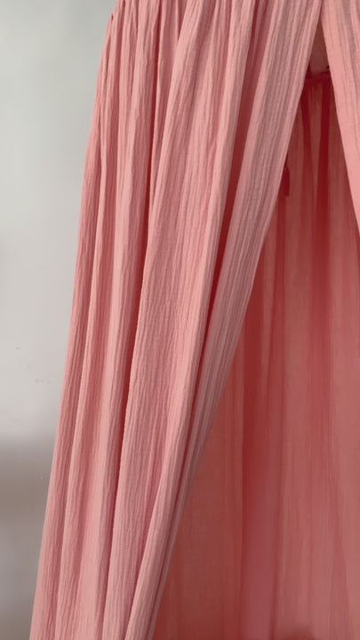 Muslin baby canopy hanging in girl's nursery