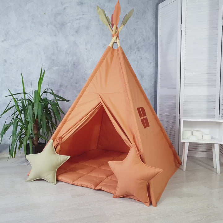 Dusty orange teepee tent for kids in boho playroom