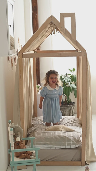 Cozy kids’ room with beige canopy curtains and minimalist decor