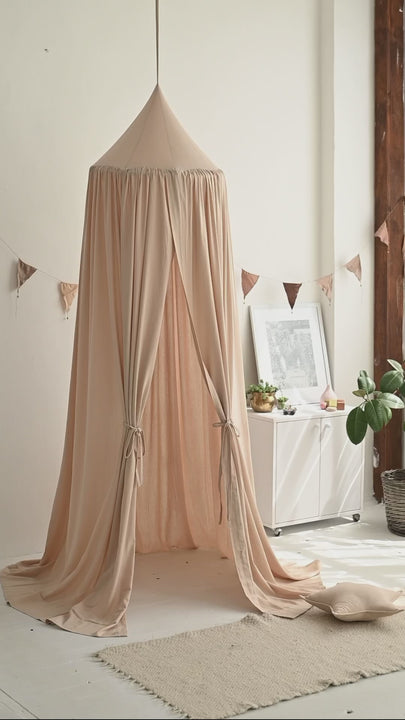 Ceiling-hung pale pink linen canopy with wide hoop