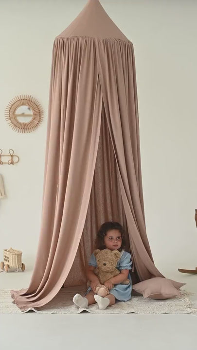 Neutral taupe canopy in minimalist nursery